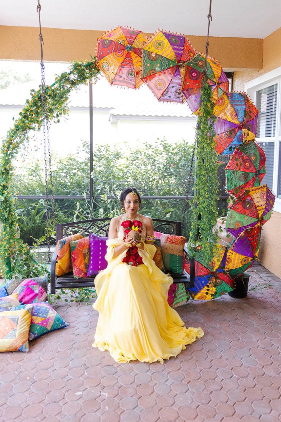 Bride on a marigold-decorated swing at her haldi ceremony, GTA