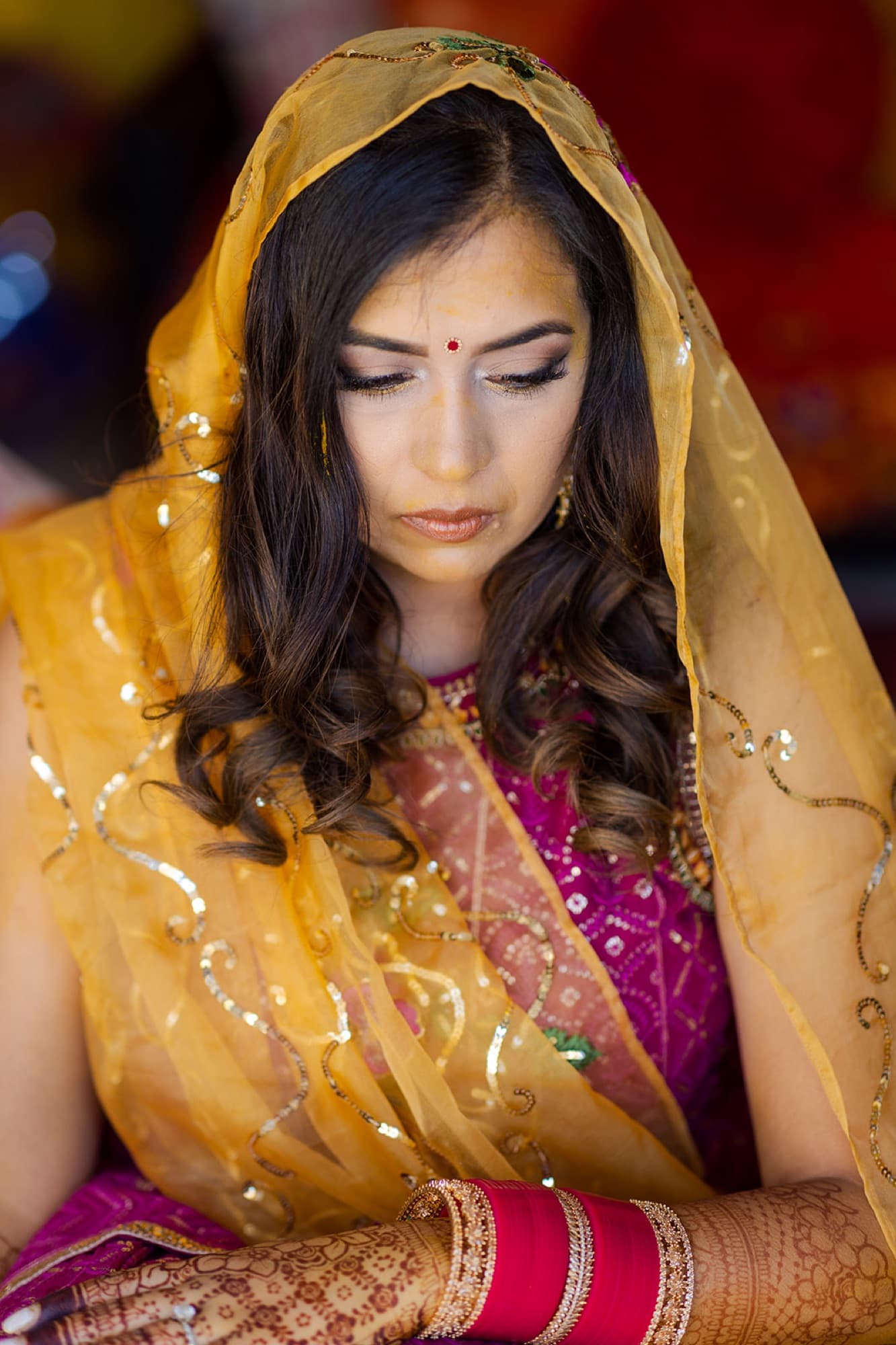 Bride veiled in gold at her haldi ceremony, Toronto