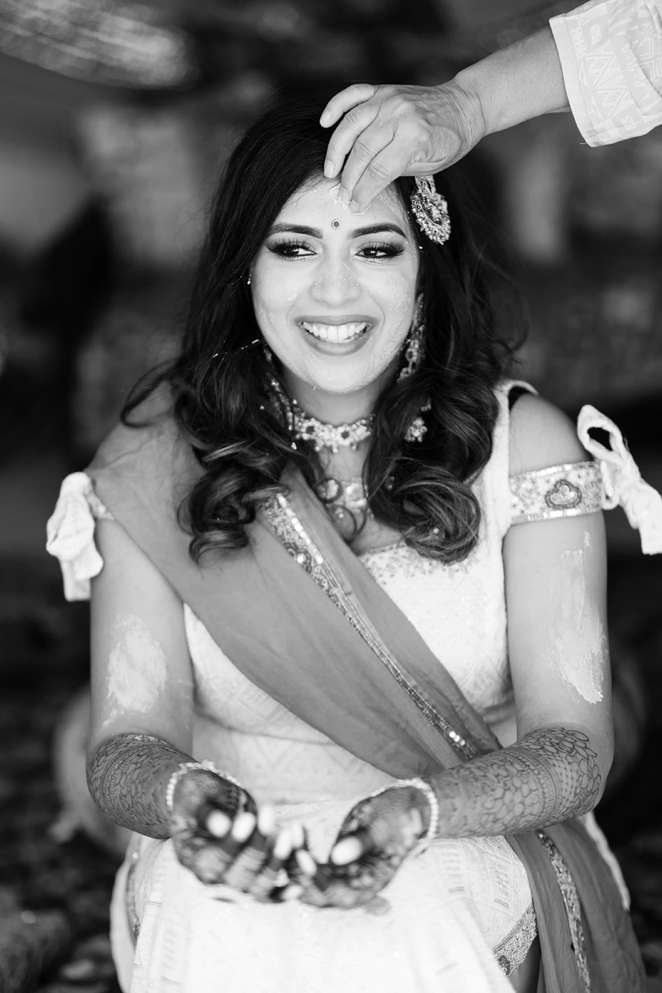 Bride laughing at her haldi, black and white, GTA