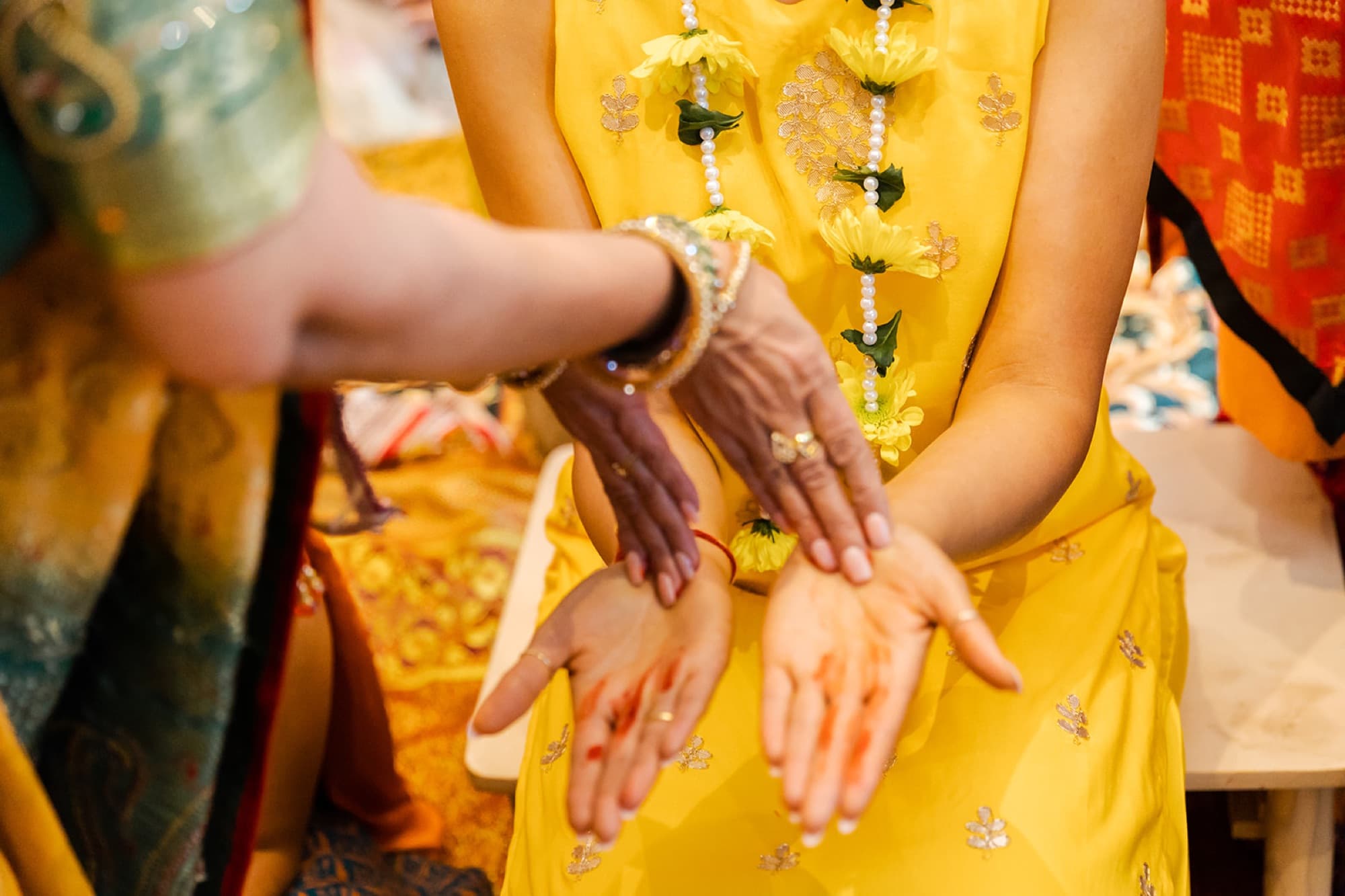 Mehndi hands dusted with turmeric at the haldi, Toronto