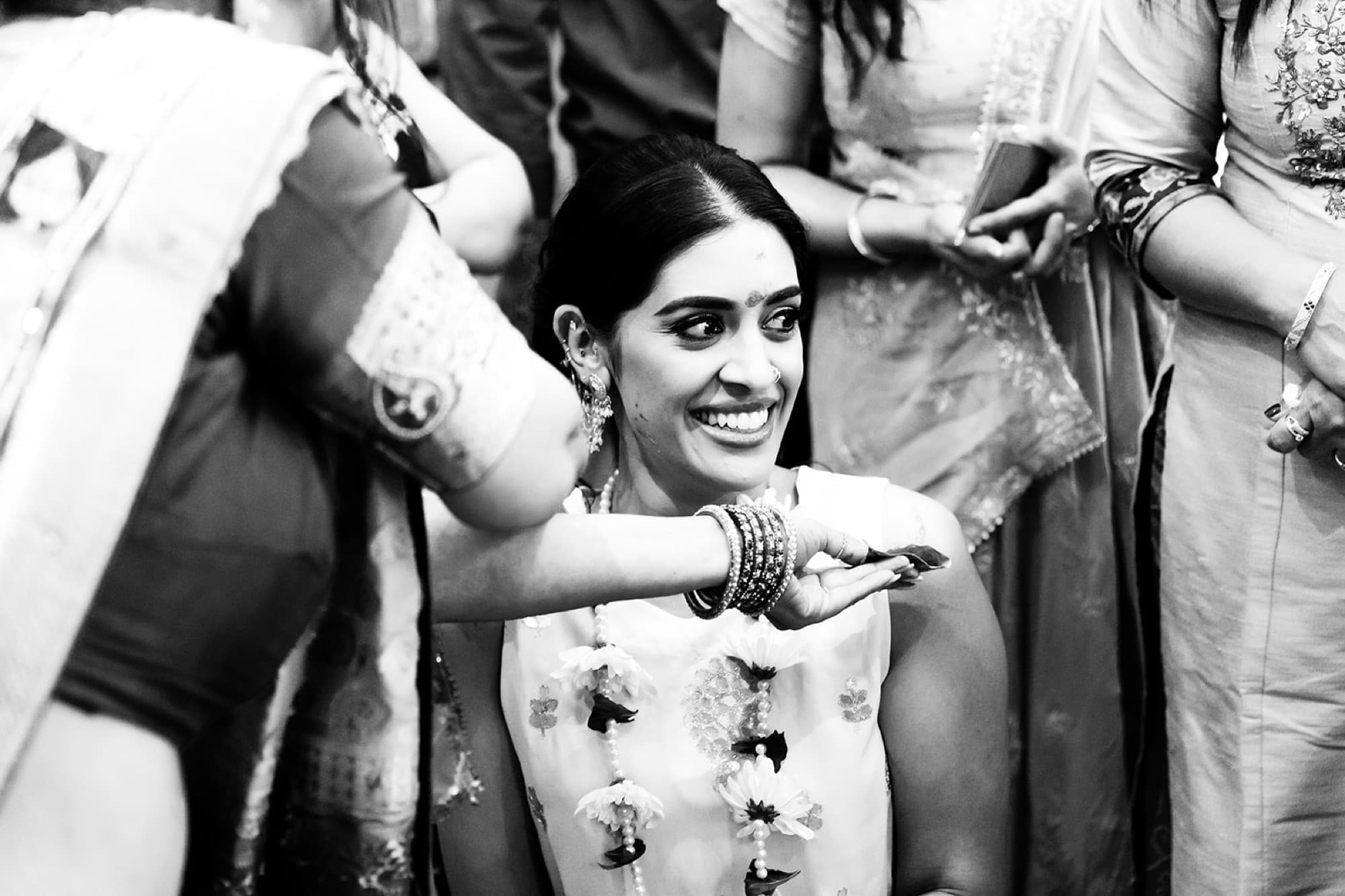 Bride laughing through the haldi application, Toronto