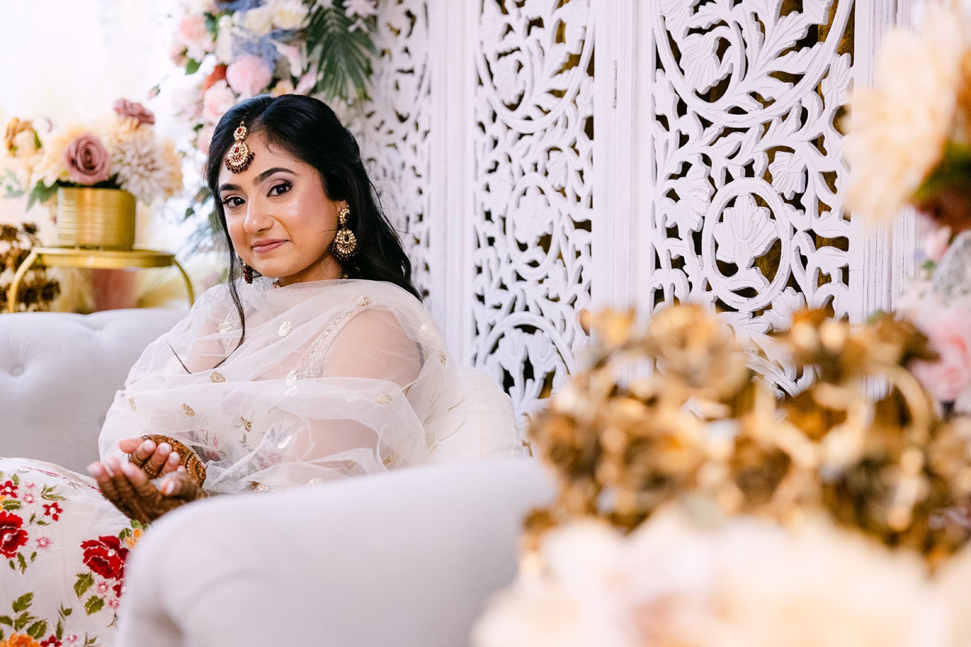 Bride at her mehndi in white florals, Toronto