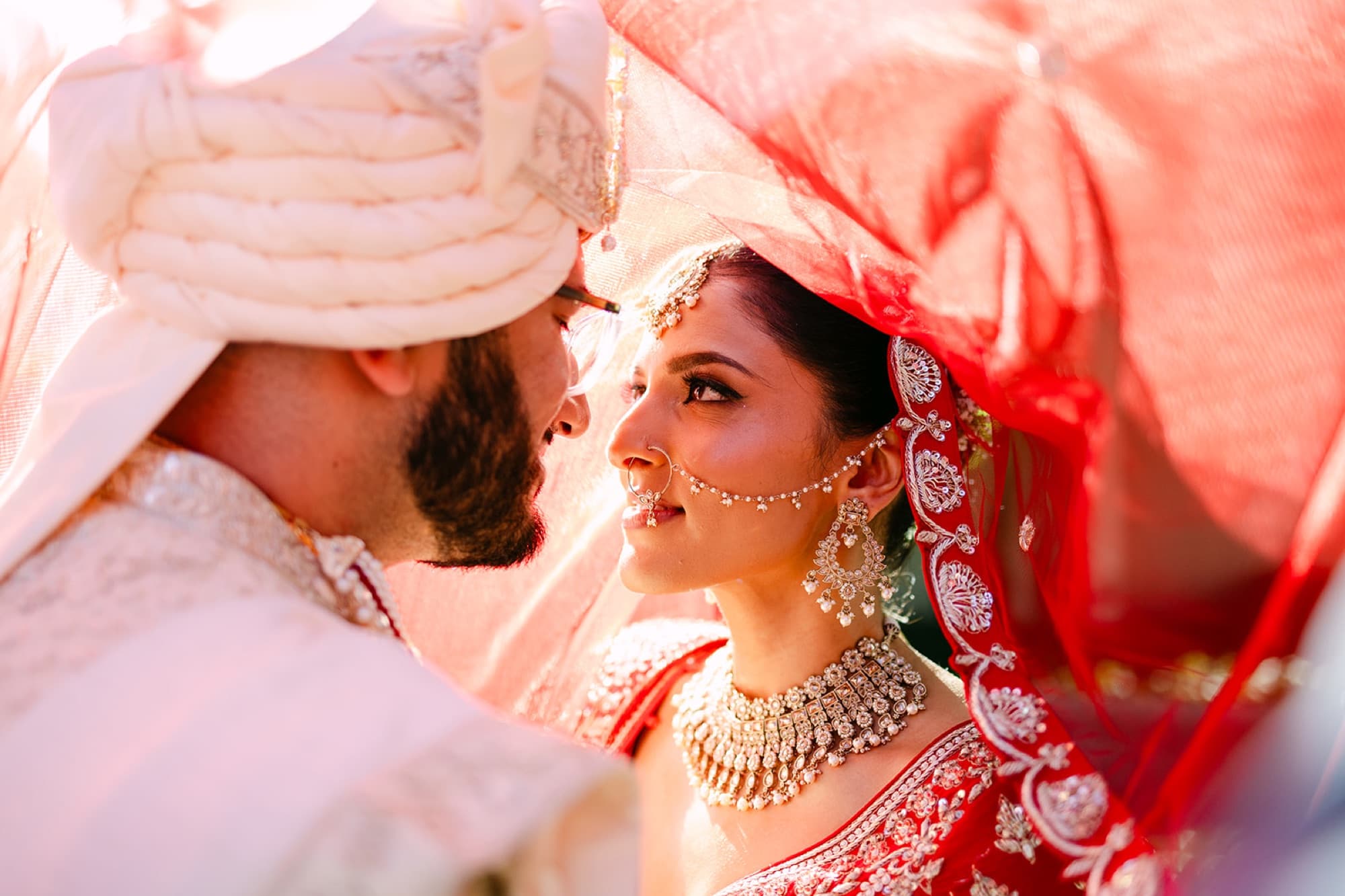 Couple beneath a pink dupatta canopy after the ceremony, GTA wedding photography