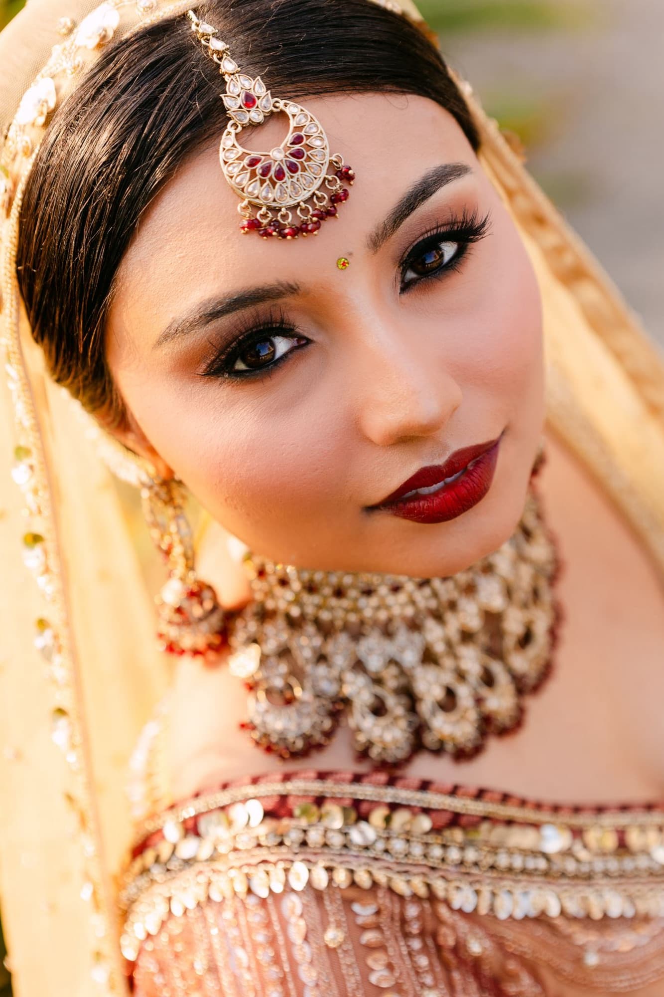 Bride in gold jewelry and warm light before the reception, Toronto