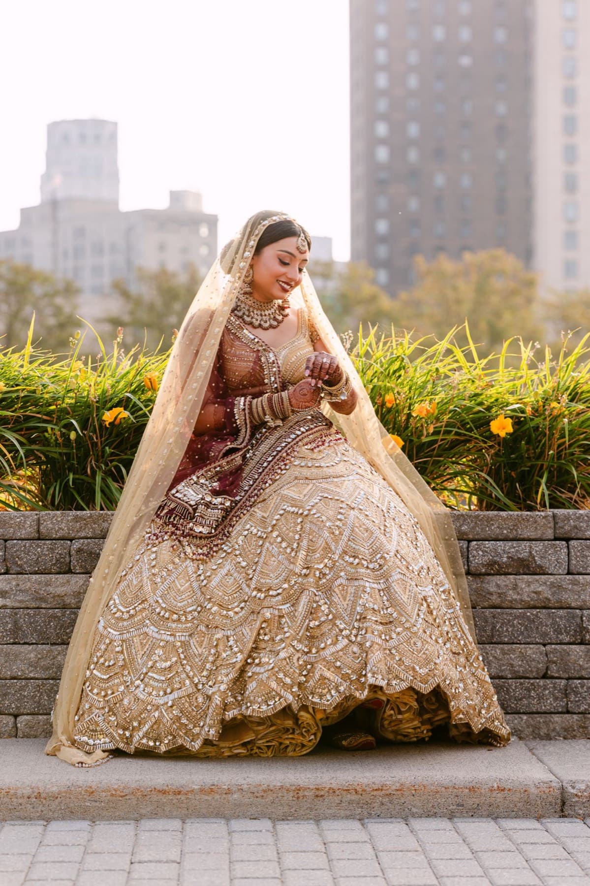 Bride in a gold lehenga in the garden before the reception, GTA