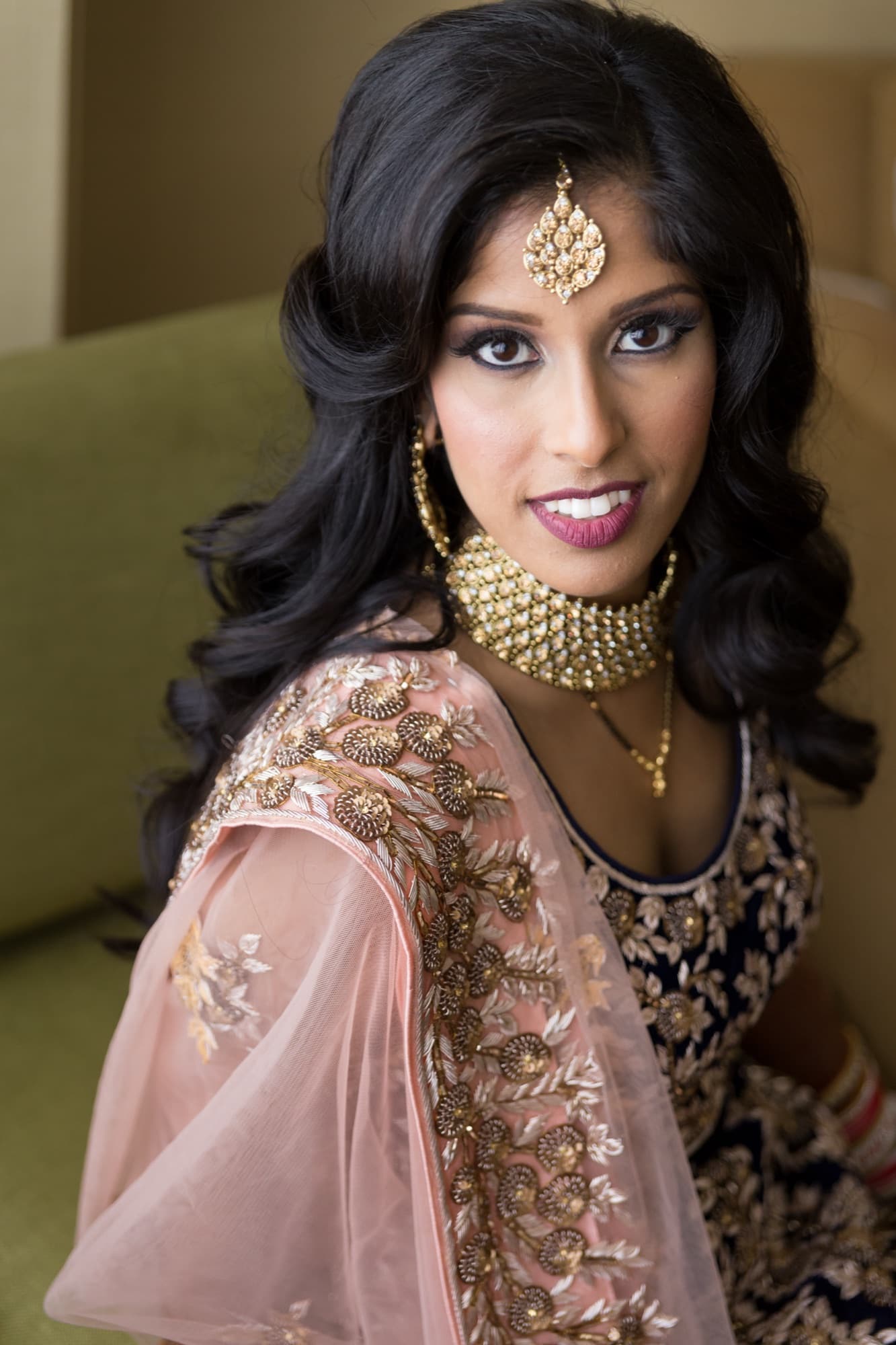 Bride at home in soft window light before the baraat arrives, Toronto