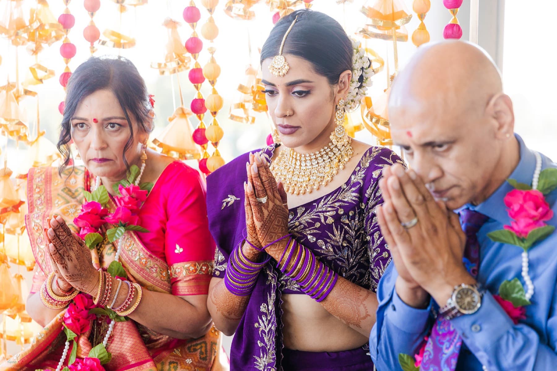 Family in prayer during the ceremony, Toronto South Asian wedding