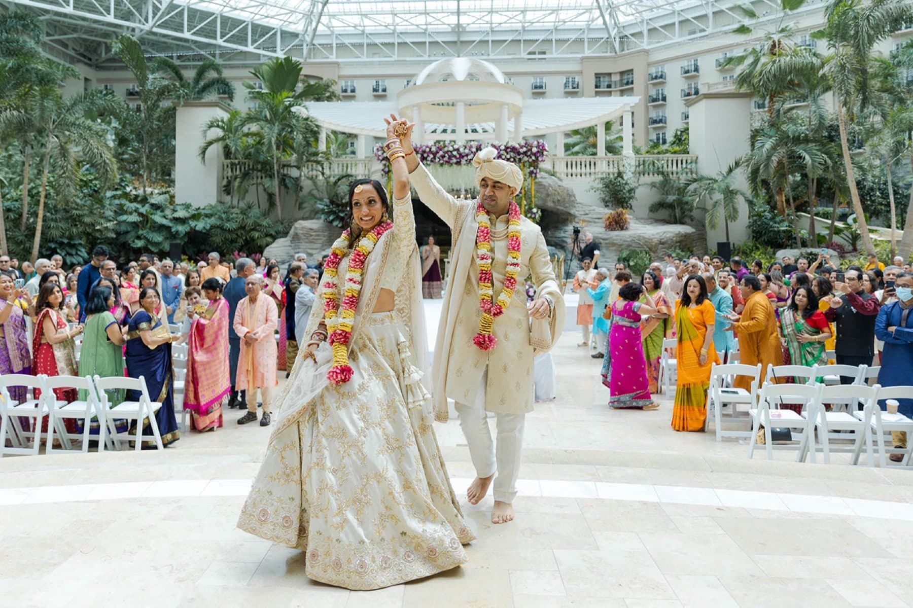 Couple in garlands celebrating the recessional, Toronto South Asian wedding