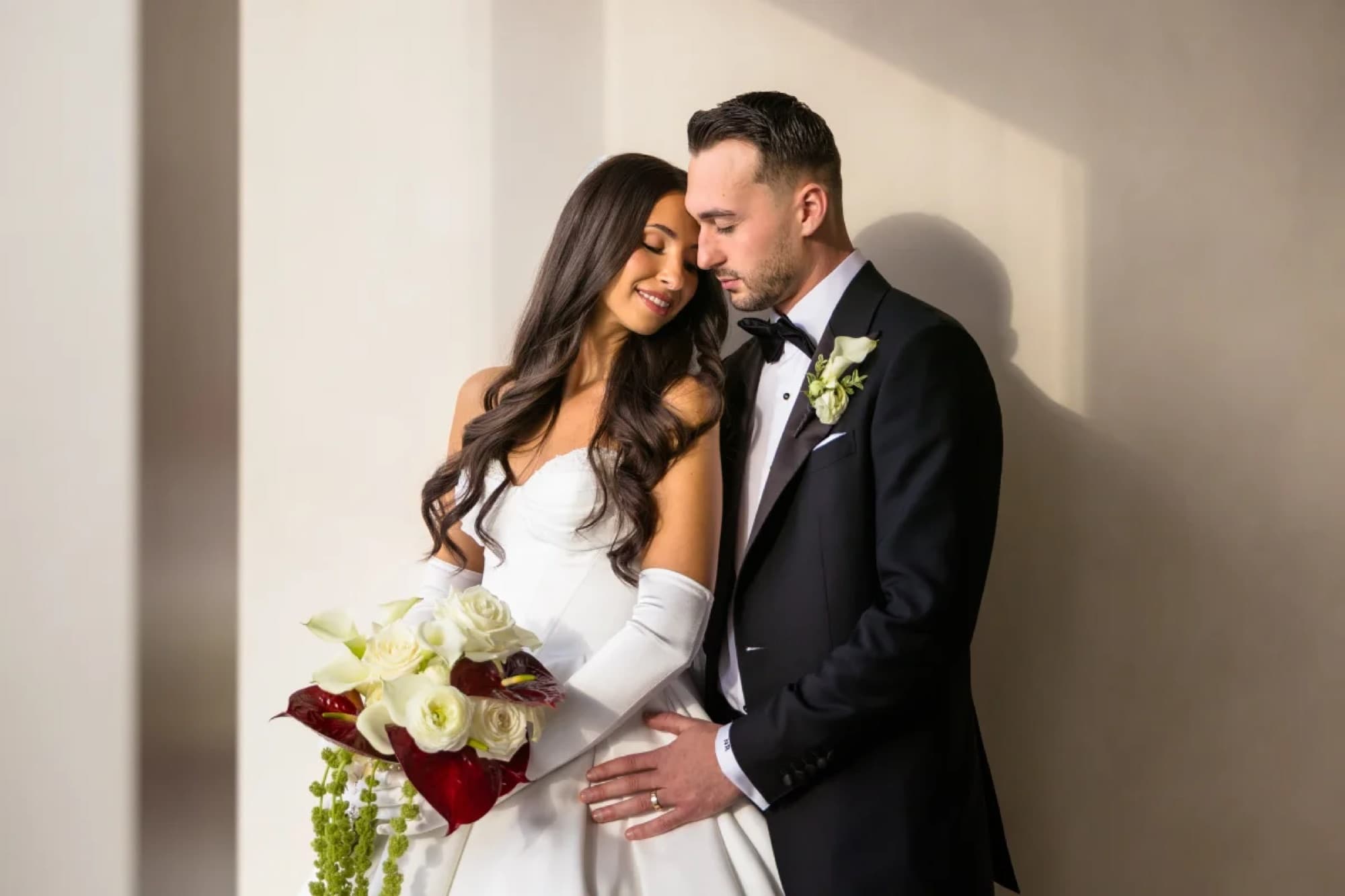 Couple portrait against a modern wall after the ceremony, Toronto