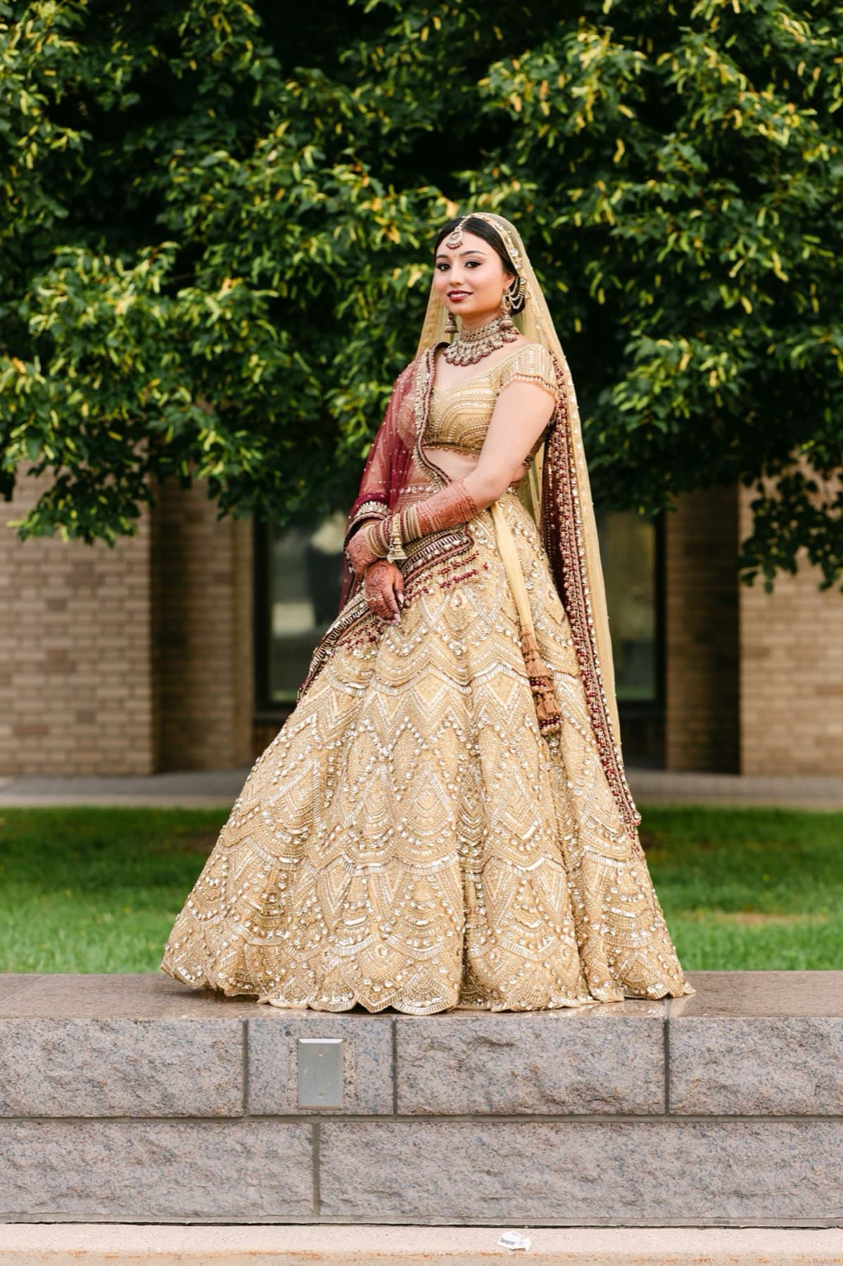 Bride in a gold lehenga in the city garden, editorial wedding portrait, Toronto
