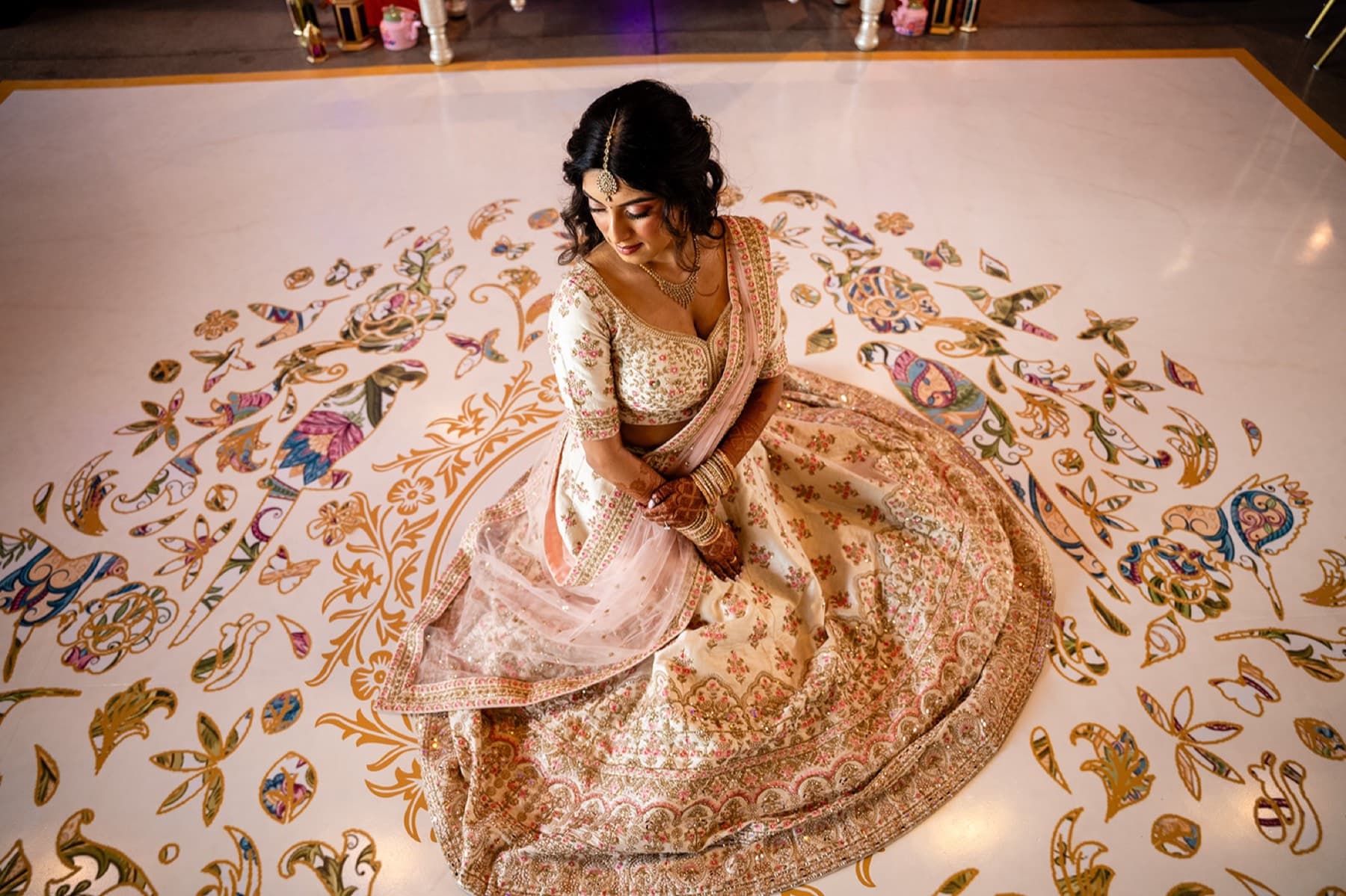 Bride's gold lehenga fanned around her, editorial bridal portrait, Toronto