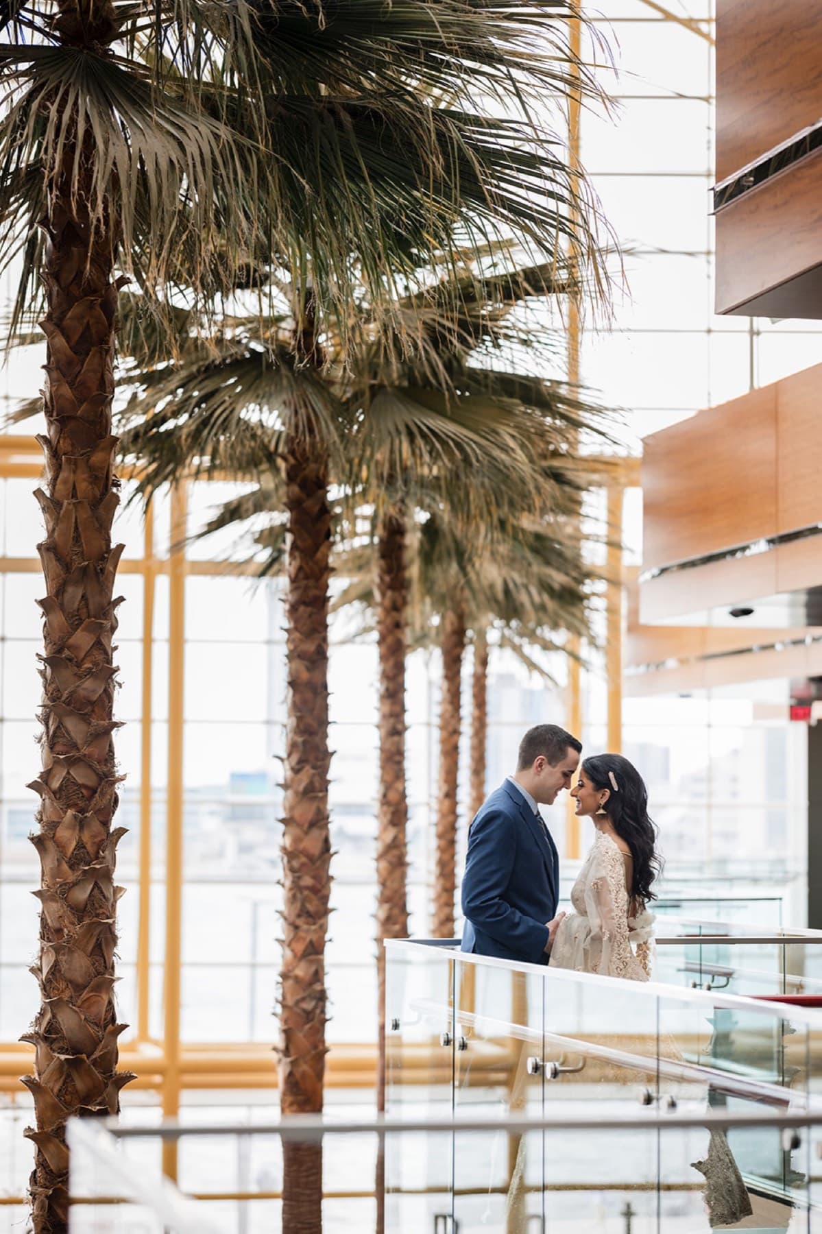 Bride in red lehenga on the grand staircase, Toronto wedding photography