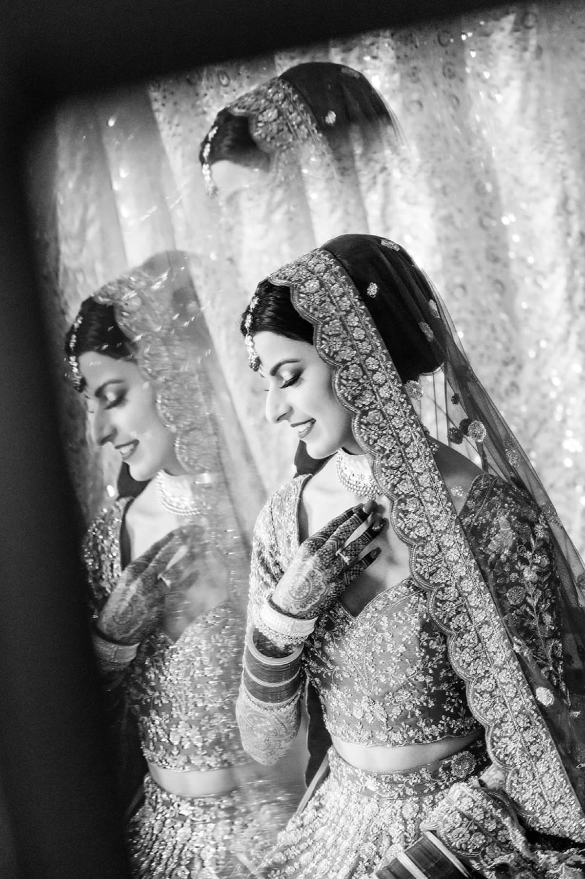 Red bridal lehenga and mehndi detail, editorial wedding portrait, Toronto
