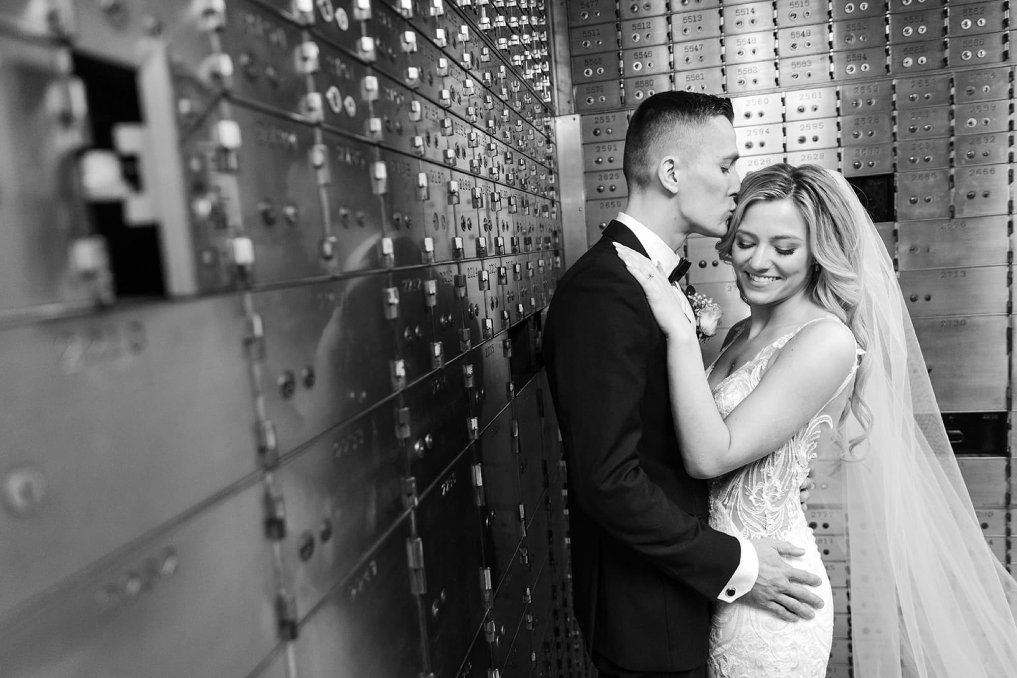 Kiss beneath the chandelier at the reception, Toronto wedding