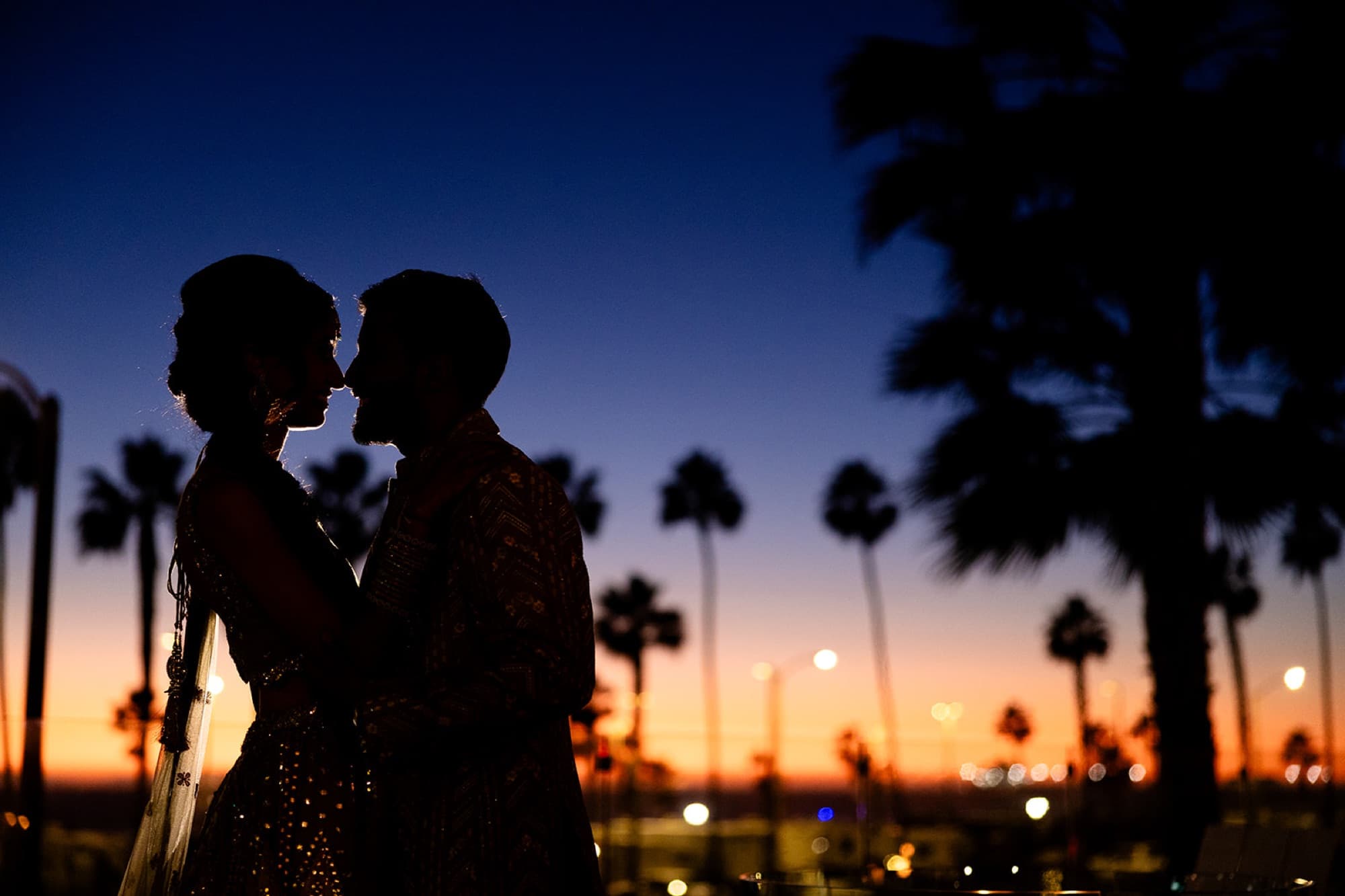 Couple silhouetted against the sunset, editorial wedding photography