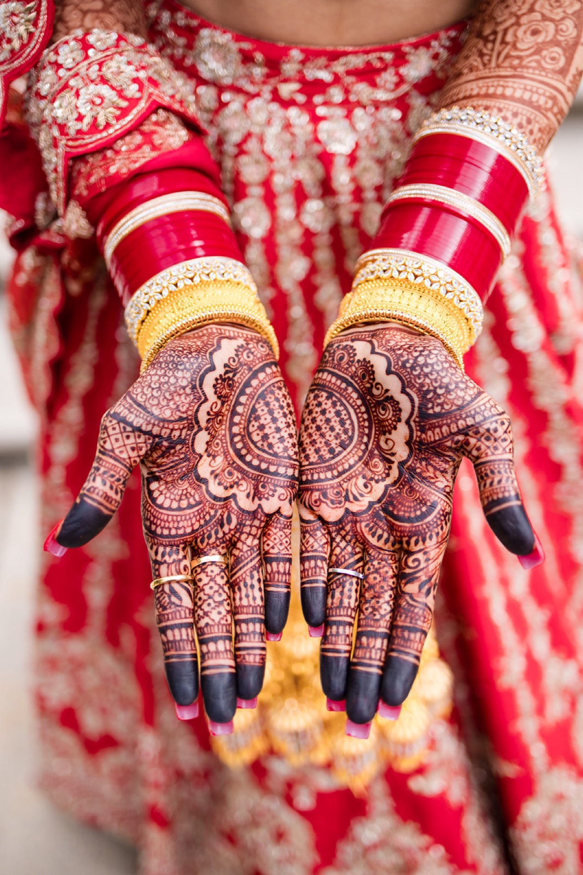 Bridal mehndi detail against the red lehenga, Toronto