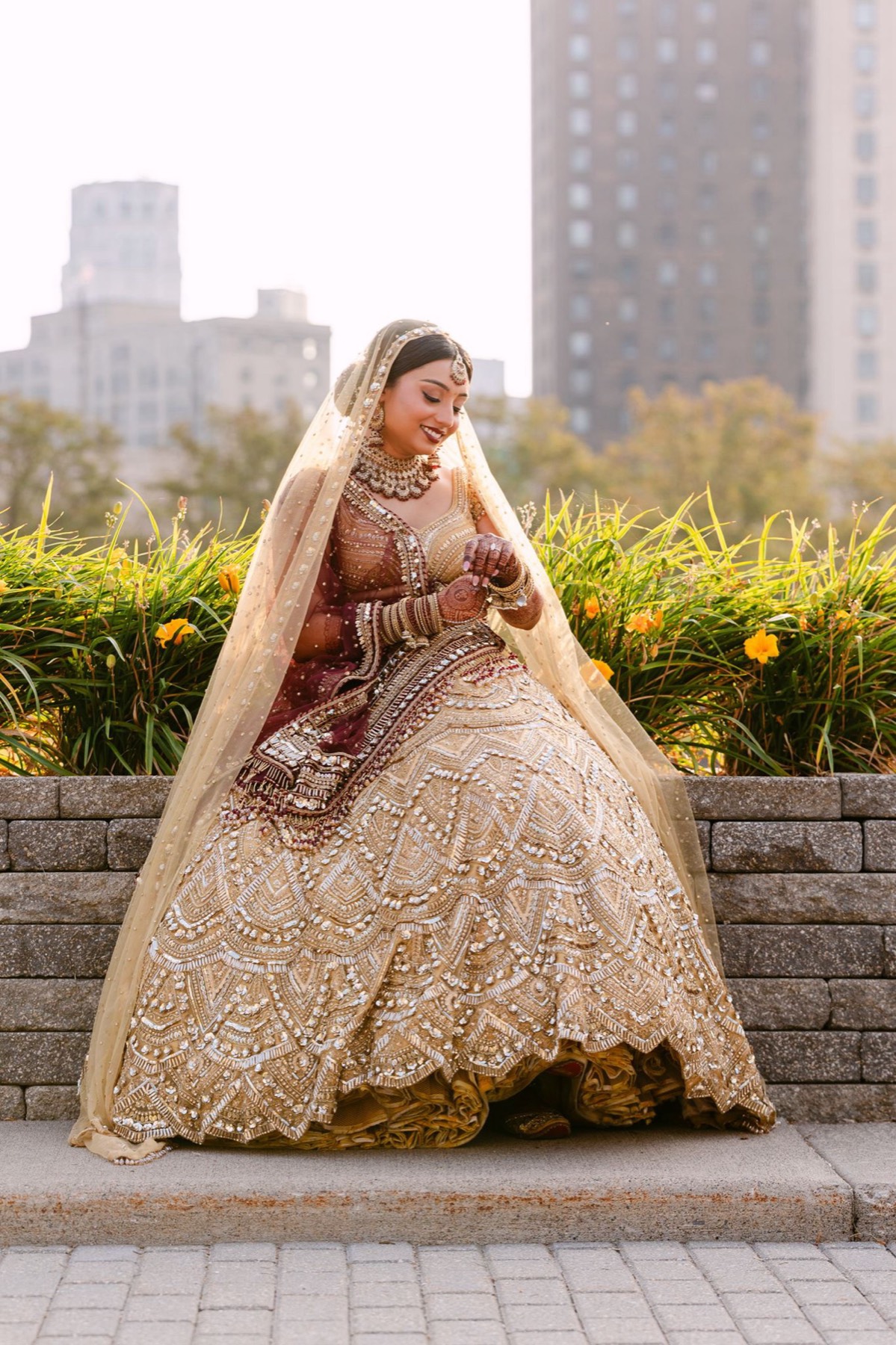 Bride in a gold lehenga in the garden before the reception, GTA