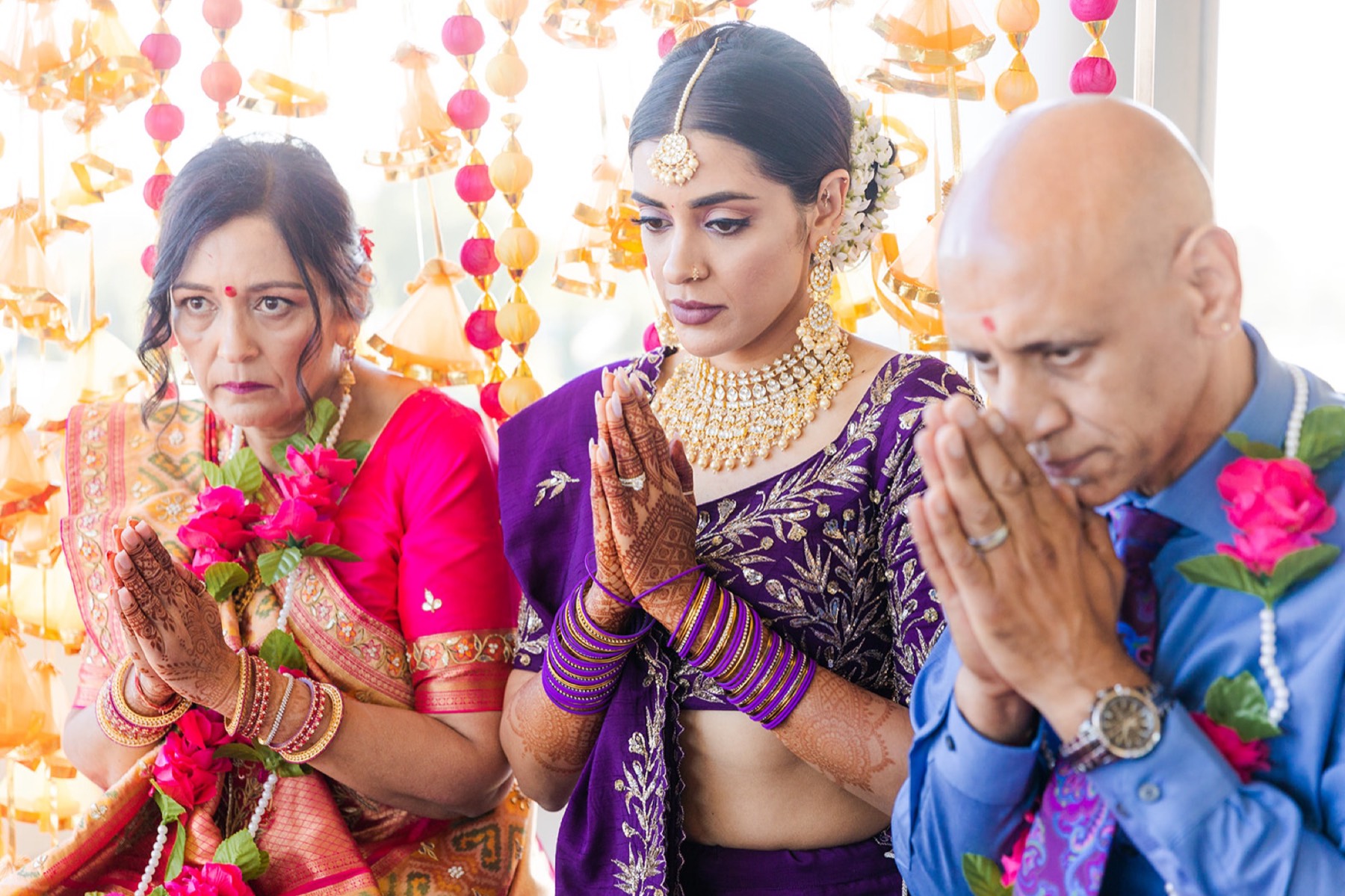 Family in prayer during the ceremony, Toronto South Asian wedding