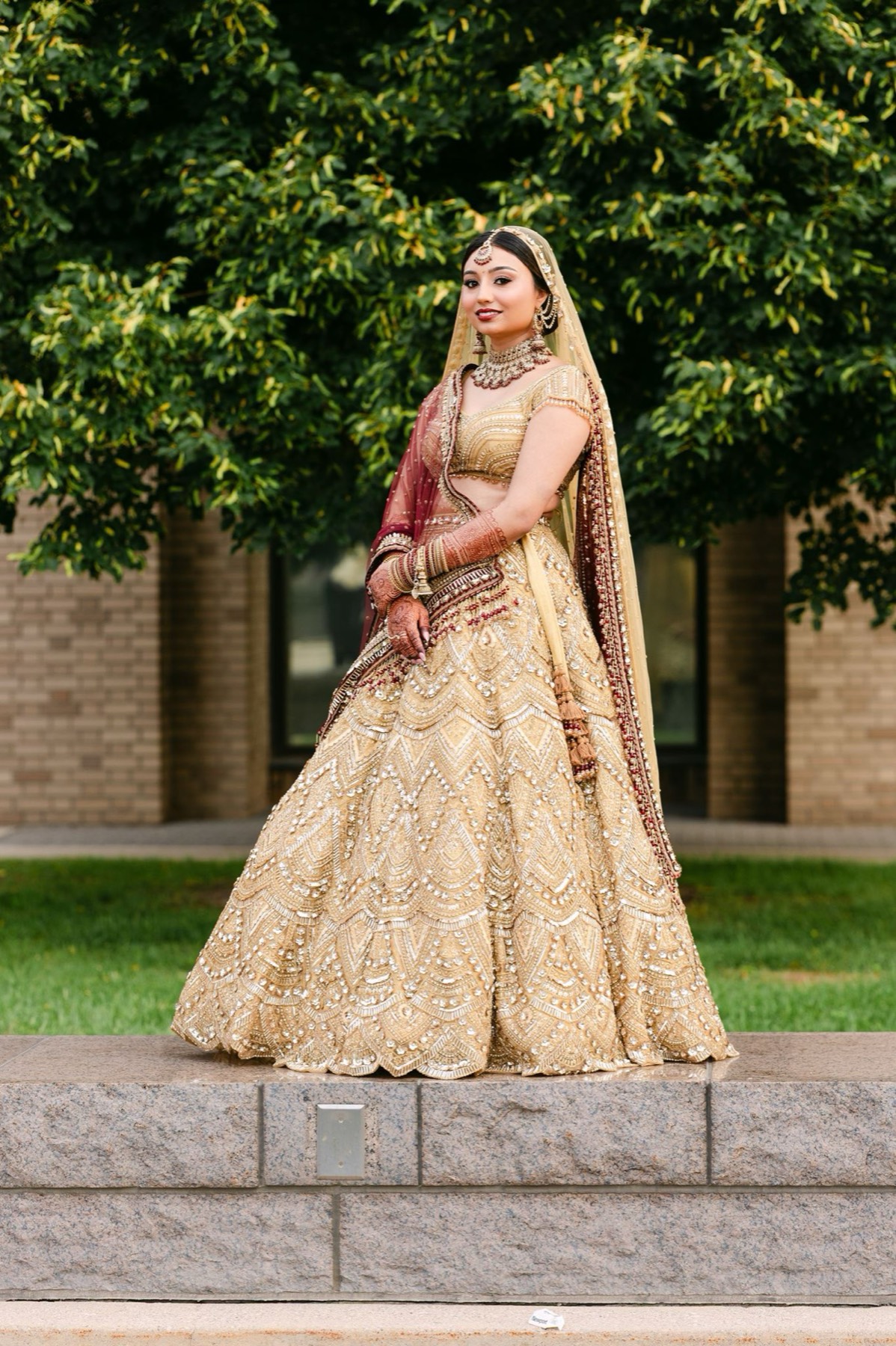 Bride in a gold lehenga in the city garden, editorial wedding portrait, Toronto